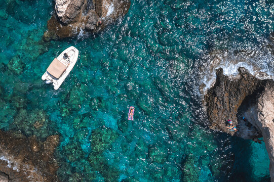 Aerial view showing Love Bridge rock formation and swimmer in clear blue water. Ayia Napa, Cyprus
