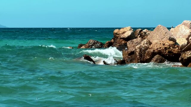 Sea Waves Splashing Against Coastal Rock Breakwater Barrier 