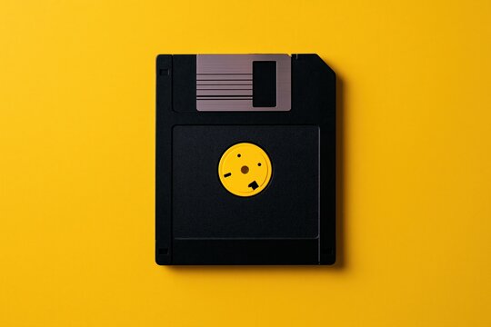 Computer Floppy Disk on Yellow Background Surface