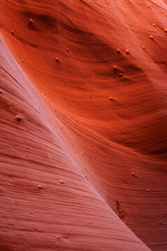Beautiful vertical abstract texture of sandstone wave rock formation with iron concretions