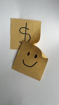 Yellow sticky notes with dollar sign and happy face financial concept