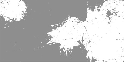Fototapeta premium Abstract textured white paint splatters on a muted grey background create a dynamic and artistic composition.