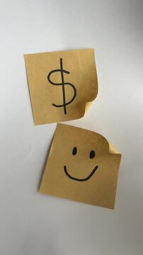 Dollar sign and smiley face sticky notes symbolizing money happiness