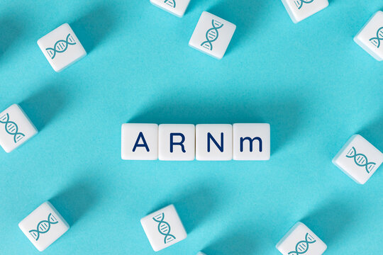 ARNm text on blocks surrounded by dna icon dice on blue background. Messenger rna genetic concept