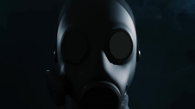 Gas mask fills closeup in dark blue shadows with covered face and round lenses