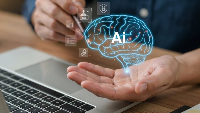 A person interacting with a glowing digital artificial intelligence brain hologram while working on a laptop computer setup