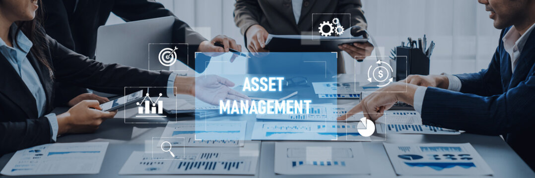A professional team engaging in asset management discussions using digital devices and charts in a modern office setting, showcasing collaboration and strategy development. Trope
