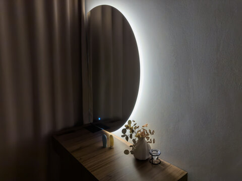 Mirror with electric backlight above dressing table in on state
