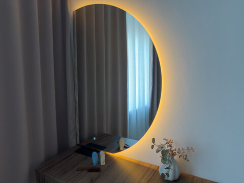 Mirror with electric backlight above dressing table in on state