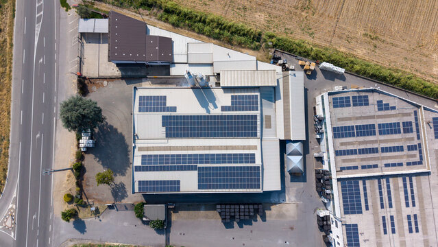 Aerial view of a specialty coatings manufacturing facility featuring extensive rooftop solar panels and industrial infrastructure in Milan, Lombardy, Italy.