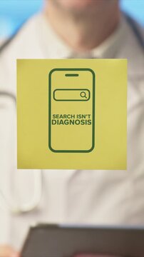 Professional male doctor holding a yellow sticky note that reads 'search isn't diagnosis', warning patients against the dangers of self diagnosing medical conditions using online search engines