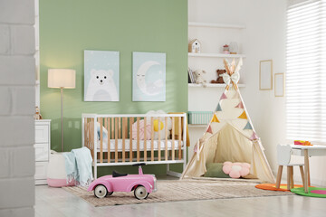 Spacious baby room with different furniture and toys. Interior design © New Africa
