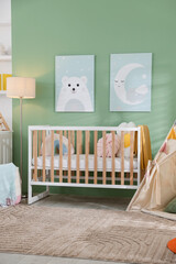 Cute baby room interior with comfortable crib, wigwam and other toys © New Africa