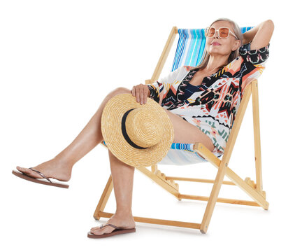 Senior woman with hat on deck chair against white background