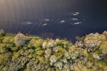 Top down view of people paddling near a green forest The Concept of active lifestyle © VicVaz