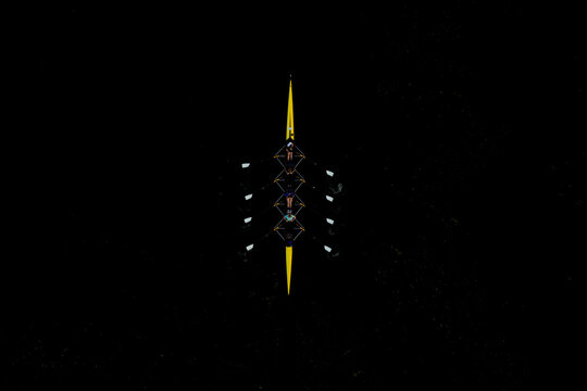 Aerial view of a yellow rowing boat with four professional rowers.