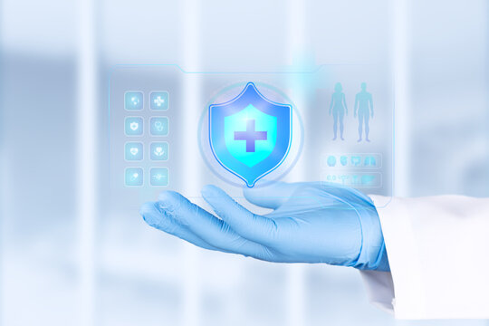 A doctor's hand, gloved in light blue, displays a health shield. Concept of prevention, financial protection, and medical well-being. Health insurance. Bokeh effect background. Isolated.