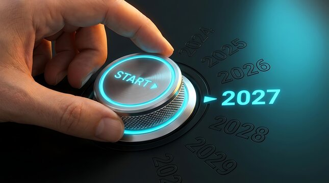 Hand turning dial to 2027 with glowing blue light and start button, beginning of new year concept.