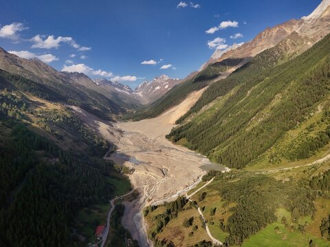Aerial view of the aftermath of a massive rock and ice avalanche from the Birchgletscher glacier, showing the debris-covered valley floor in Blatten, Wallis, Switzerland.