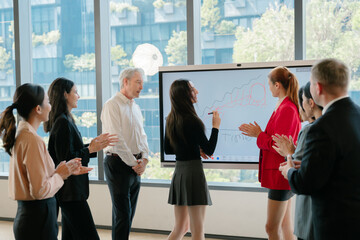 Obraz premium Business people at work coordination meeting concept showing joyful team clapping and appreciating colleague presentation in modern office