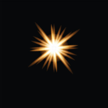 Bright glowing golden star light flare effect isolated on a deep black background