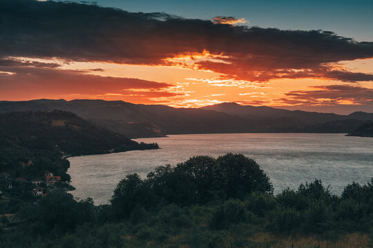 Sunset over the Danube reservoir near Donji Milanovac in Djerdap Park, Serbia, with mountains and calm water glowing in warm evening light