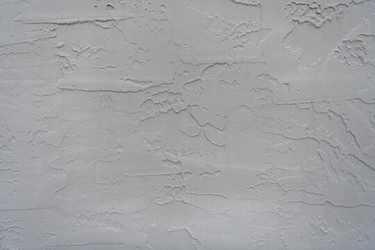 Plaster wall background. Grey abstract background. Plaster wall texture. Texture of gray decorative plaster or concrete. Abstract grunge background for design. Gray cement plaster texture