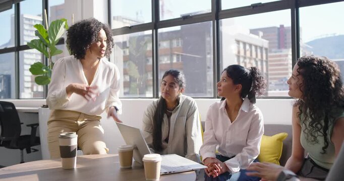 Diverse female team watching African American woman pointing at laptop, sparking ideas, copy space
