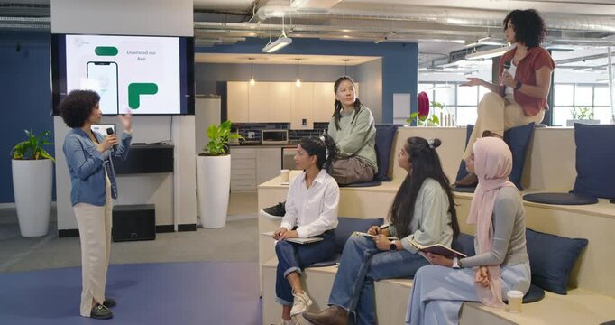Diverse-office watching lead mic pointing at app pausing top-right raising mic asking, copy space
