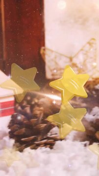 Animation of stars floating over christmas decorations