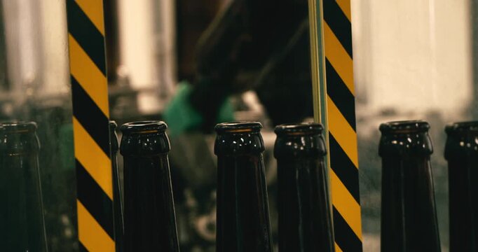 Beer Factory &ndash; Beer Bottles on Conveyor Belt Before Cleaning and Filling in Industrial Brewery, Germany, Berlin, Europe
