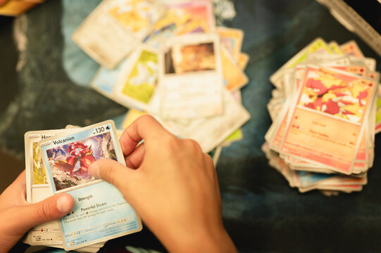 Chicago, IL/USA - August 27, 2026: Child sorting Pokemon trading cards into separate piles