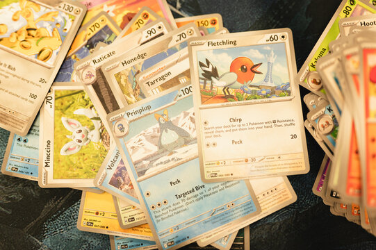 Chicago, IL/USA - August 27, 2026: A large assortment of Pok&eacute;mon trading cards is spread across a surface while being sorted and organized into different piles. This image highlights card collecting