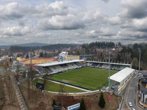 Jablonec nad Nisou, Czech Republic - March 23, 2025: Aerial view of Stadion Strelnice, home of FK Jablonec, with the football pitch, stands, and surrounding hills.