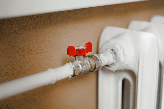 Radiator valve in residential room, home heating control and indoor temperature system concept
