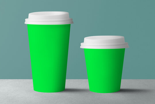Vibrant green coffee cups displayed, suitable as mockup