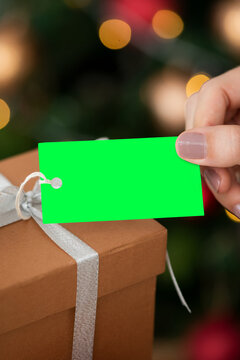 Gift tag held over present, suitable as mockup
