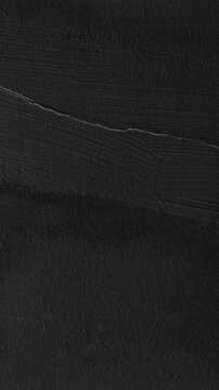 Dark textured mobile wallpaper with a rough, matte black surface and subtle linear details