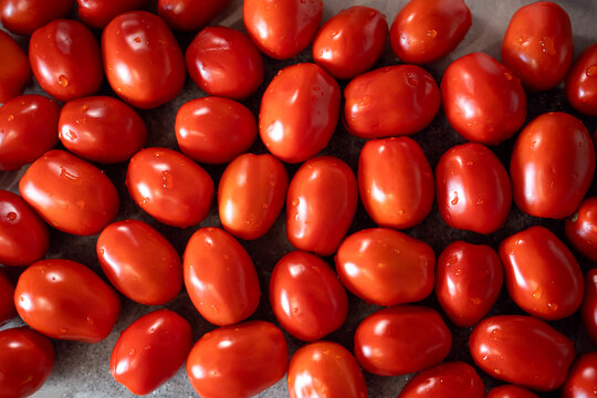 Fresh red tomatoes as background