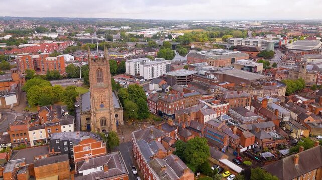 High angle perspective of cathedral tower surrounded by red rooflines