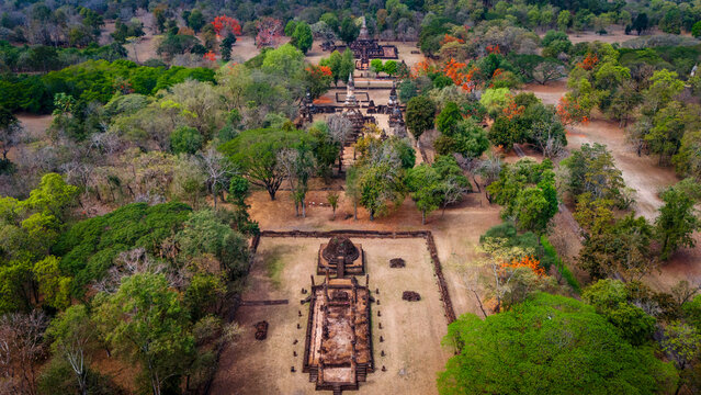 Aerial view of Si Satchanalai Historical Park with ancient temple ruins, stone structures, and lush green trees in Si Satchanalai, Sukhothai, Thailand.