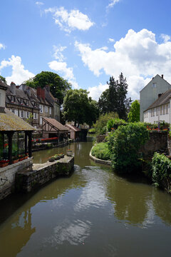Half-timbered houses along the Eure river with lush greenery, Chartres, France