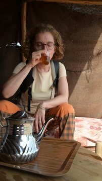 Marrakech, morocco. August 9, 2026. Adult woman savoring a traditional hot mint tea in marrakech. Authentic moroccan hospitality experience during a desert travel adventure