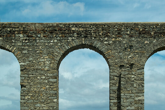 Historic stone aqueduct crossing Evora road