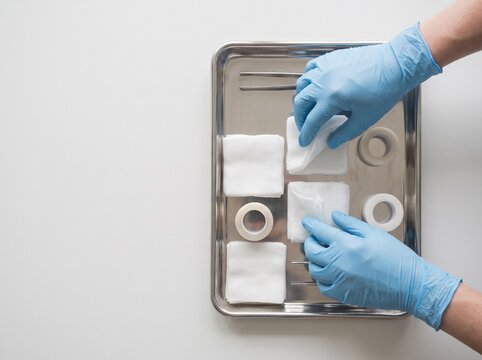Healthcare Professional Organizing Sterile Wound Care Supplies on Medical Tray