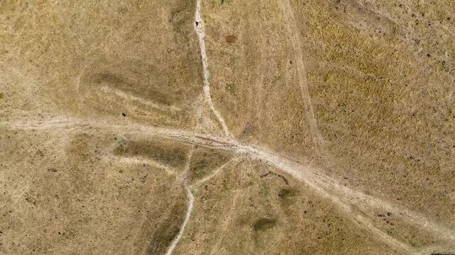 An aerial rotating rising view over the entrance to the remains of the Iron Age Hillfort in rural Leicestershire, UK in late summertime
