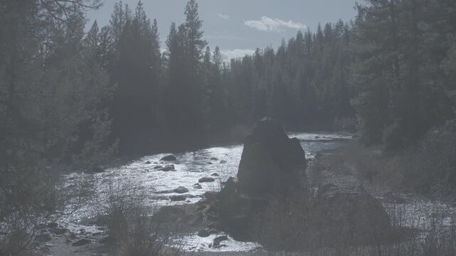 Sunlit Mountain River Flowing Past Large Boulder