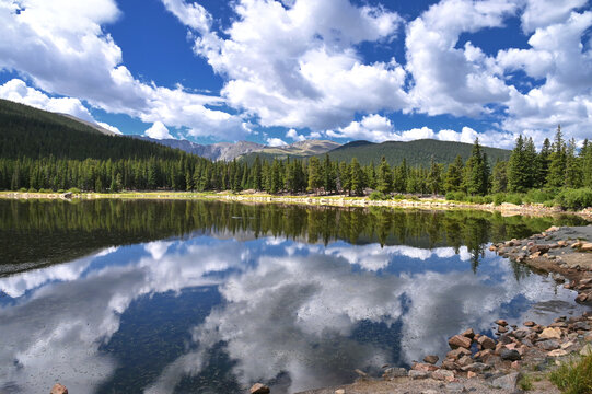 Echo Lake in the Colorado Rocky Mountains with pine trees, blue sky and clouds, Idaho Springs CO