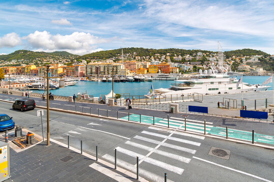 The colorful Old Port of nice, Port Lympia, with colorful buildings filled with shops cafes surrounded the busy marina on the French Riviera at Nice, France.