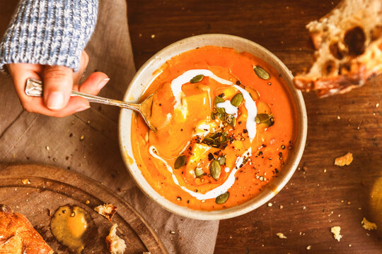 Creamy pumpkin soup with seeds and bread